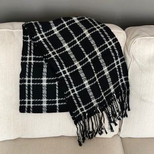 Black and white scarf with tassel fringe.